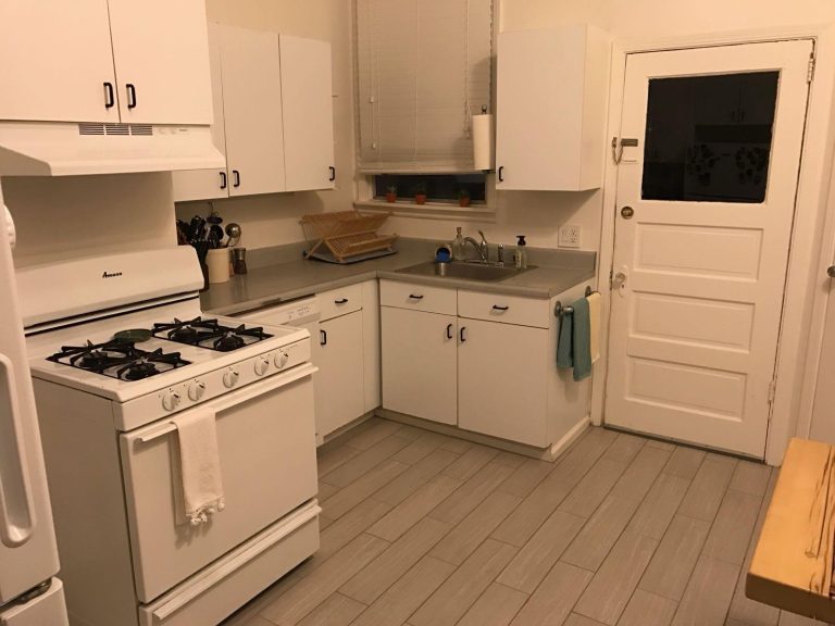 Spotless white kitchen with clean stove and countertops