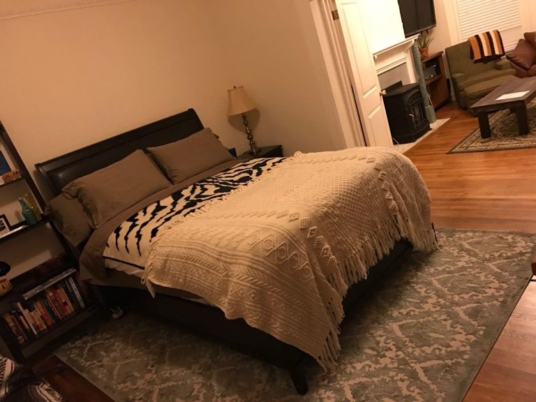 Tidy bedroom with a freshly made bed and clean floors